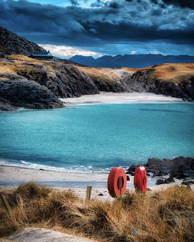 Clachtoll Beach with white sands and crisp blue sea in the North Coast 500 in Scotland