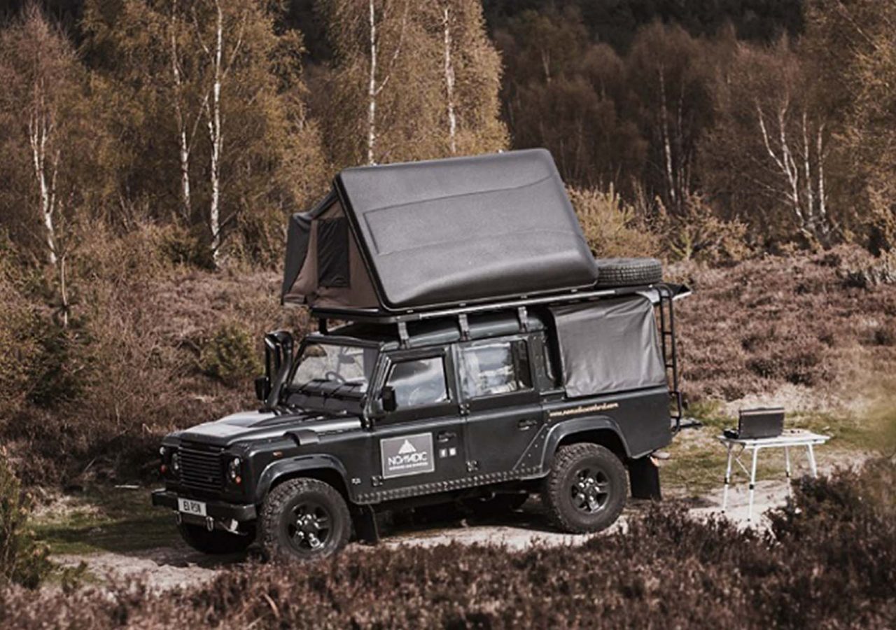 A Nomadic Scotland Land Rover in the Scottish wilderness with a roof tent on top