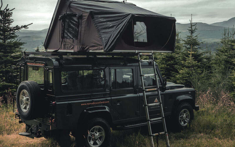 A Land Rover with a roof tent from Nomadic Scotland