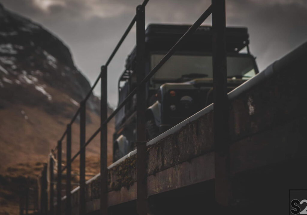 A 4x4 driving across a bridge in Scotland.