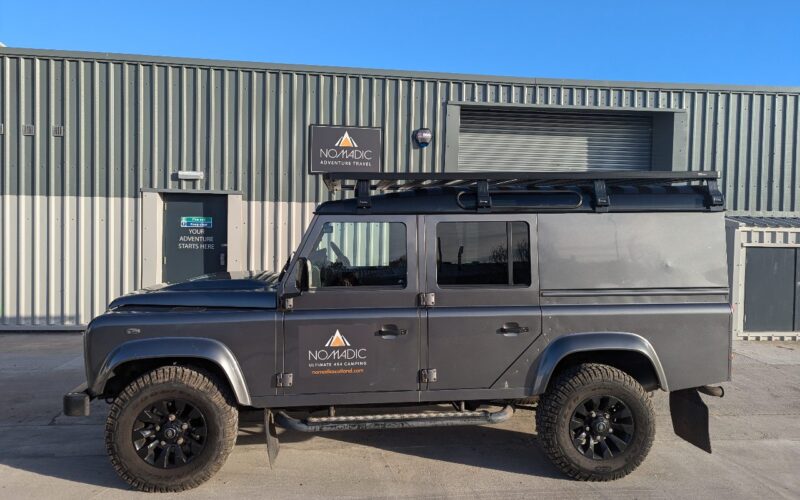 A Landrover defender 4x4 vehicle for hire on a sunny day in Scotland.