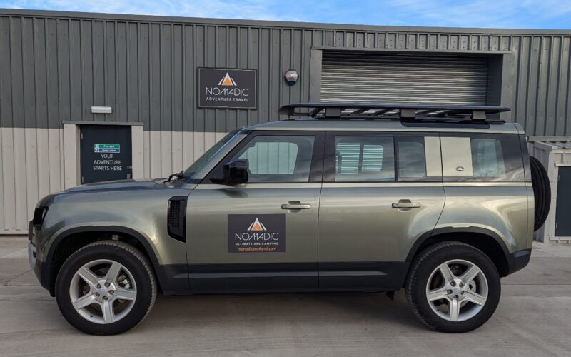 A new style Land Rover 4x4 vehicle for hire on a sunny day in Scotland.